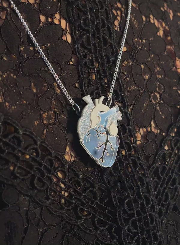 Video of the Anatomical Heart Necklace - Silver worn over black lace.